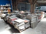 a large pile of books sitting on a pallet in a warehouse