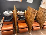 a room with a bunch of chairs and sinks in it