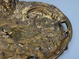 a gold plate with a picture of a sheep on it