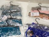 several bags of clothes are wrapped in plastic bags on a table