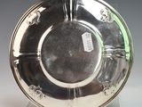a silver plate on a stand with a tag on it