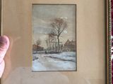 someone is holding a picture of a snowy landscape in a gold frame