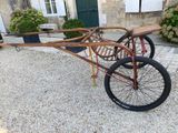 a bike that is attached to a cart in front of a house