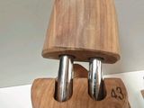 a wooden knife holder with two knives on top of it