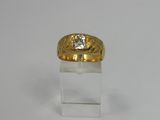 a close up of a gold ring with a diamond on it