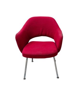 the red chair is sitting on the metal legs of the chair
