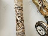 a pen that is sitting on a table next to a pocket watch