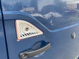 a close up of a blue van with a number on it
