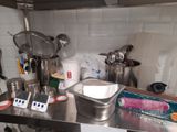 stainless steel counter top in a commercial kitchen with pots and pans on it