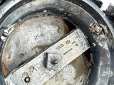 a close up of a metal object on a white surface
