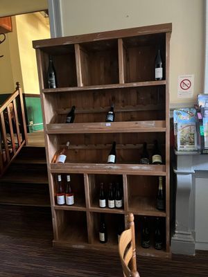 une étagère en bois sur laquelle sont posées des bouteilles de vin