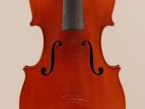 an old violin with a bow hanging from it ' s back