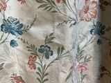 a close up of a bed with a floral pattern on it