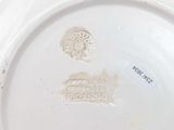 a white plate with a brown design on it