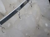 a lot of ice balls hanging from a metal rack