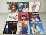 a lot of different album covers on the table