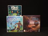three games on a black surface with a black background