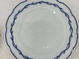 two plates and a bowl sitting on a table