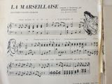 an old sheet music book with a drawing of a woman playing the piano