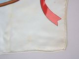 a piece of paper with a red ribbon on it