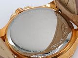 a close up of a wrist watch with a gold case