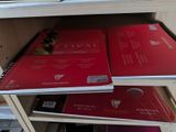 several books are stacked on top of each other on a shelf