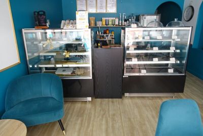 a blue chair sitting in front of a glass display case