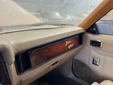 a dashboard of a car with a wooden panel on it