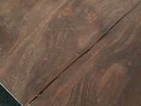 a close up of a wooden table with a black table top