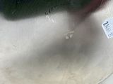 a silver vase with a flower in it on a table