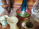 many glass vases and other items sitting on a table