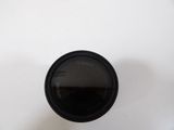 a close up of a camera lens on a white surface