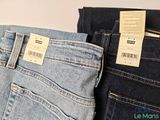 two pairs of jeans with tags on them on the back of them