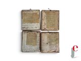 three old books with writing on them sitting on top of a table