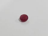 an oval red ruby gems on a white surface
