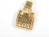a gold plated metal object with holes on it