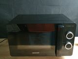 a microwave that is sitting on a table with a bowl in it