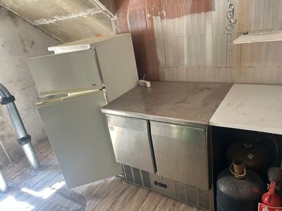 a small kitchen with a refrigerator and a stove in it