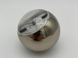 a silver ball with a clock in it on a white surface
