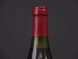 bottle of red wine on a black table with a dark background