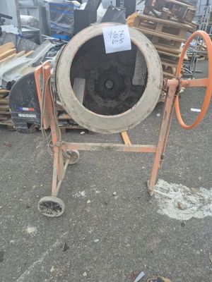 a cement mixer that is sitting on the ground