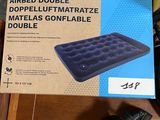 boxes of airbeds on a table with a pair of gloves on it