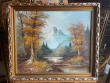 an oil painting of a mountain scene in a gold frame