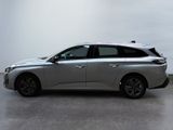 the silver car is parked on the concrete floor in the room