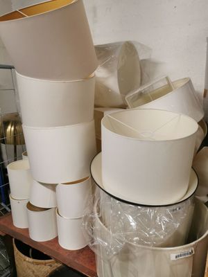 many cups and bowls on a shelf in a room