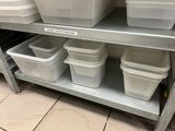 many plastic containers on a metal shelf in a kitchen
