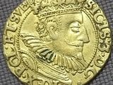 a close up of a gold coin with a crown on it