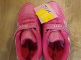 a pair of pink shoes that are on the floor