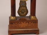 a clock that is sitting on top of a wooden stand