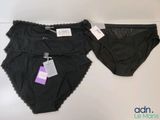 two pairs of panties with tags on them sitting next to each other